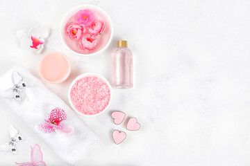 Spa and wellness composition with aromatic rose water, salt, roses and sakura, towels, aromatherapy and skin care, lifestyle concept, invitation and advertising card, selective focus