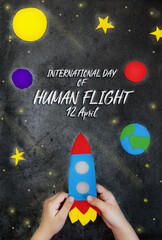 International day of human space flight. Hands child holding space rocket against the background of space and planets with stars. 12 April World Cosmonautics Day. Greeting card.Top view