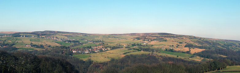 panoramic view of the calder valley in west yorkshire with the village of midgley and dod naze surrounded by fields, woods and moorland
