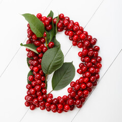Letter D from summer harvest of cherry on white wooden background. Fruit summer alphabet. Sweet mood font. Letter D from green leaves and cherry berries. Colorful ABC, Text
