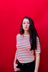 Portrait of a young girl on red background