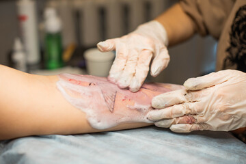 Tattoo. Hands of a tattoo artist up close. The tattoo master washes the tattoo after the session.
