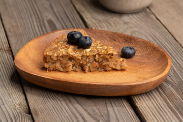 Piece of oatmeal pie on wooden plate