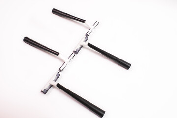 Four black disposable razors isolated on white background