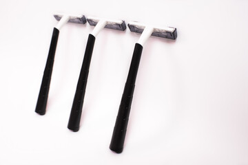 Three black disposable razors isolated on white background