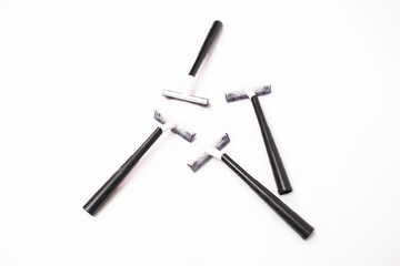 Four black disposable razors isolated on white background