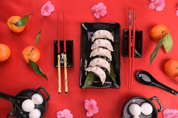 Chinese new year food and drink still life. Steamed dumpling, Tangyuan rice balls, fortune cookies...