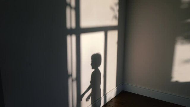 Shooting with a pistol. The silhouette of a child shoots with an imaginary pistol.