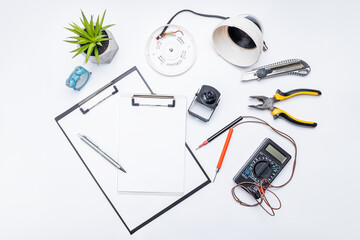 cctv camera service repair concept. above view. adjusting surveillance camera using tools on white desk