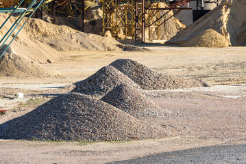 Pile of gravel and sand piled up in a quarry for sale and use in construction.