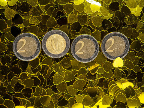 Sign 2022 Made Out Of Coins On A Gold Heart Confetti Backdrop. Copy Space. Abstract Finance Background