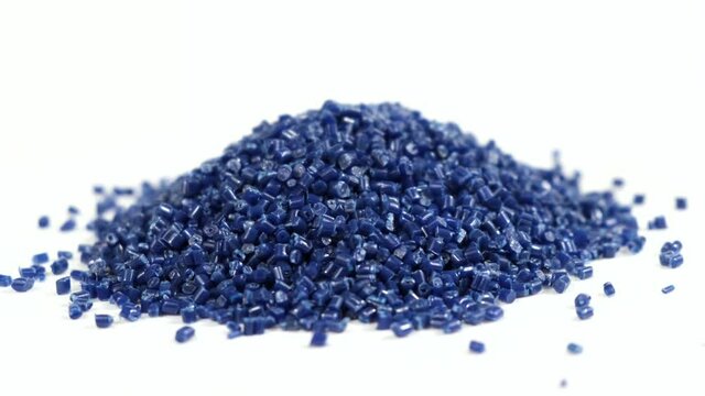 Secondary granule made of polypropylene, Dark blue plastic pellets crumbles on isolated background. Plastic raw materials in granules for industry. Polymer resin. Raw plastic recycling concept