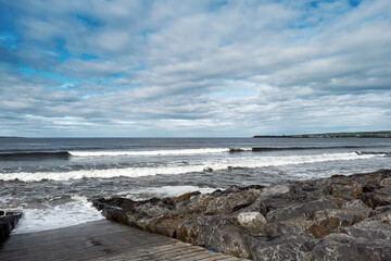 Path to the ocean. West coast of Ireland, Lahinch town, county Clare. Blue cloudy sky. Nobody. Irish landscape