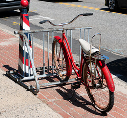 Vintage bicycle with a white banana seat in a bike rack