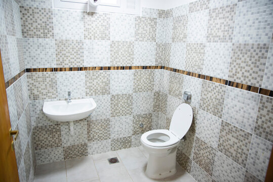 Public Restrooms Of The School. With Modern Design, New Hand Wash, Beautiful Colored Tiles, Faucet With Mirror And Window.