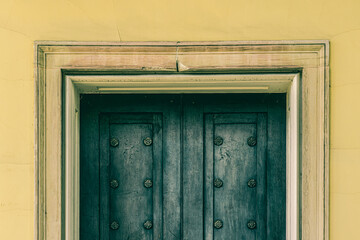 Double Door with Insets and Circular Knots in a Deep Set Cream Colored Frame Background