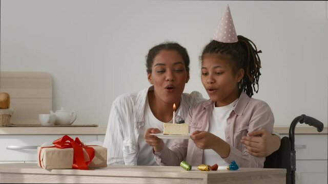 Happy Handicapped Girl And Mother Celebrating Birthday At Home