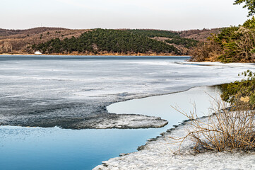 The landscape of Jingyuetan National Forest Park in Changchun, China with melting snow