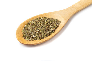 Top view, closeup of dried oregano on a wooden spoon