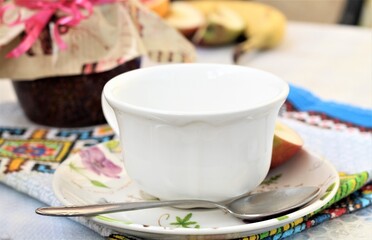 Obraz na płótnie Canvas porcelain white cup of coffee with jam on the table