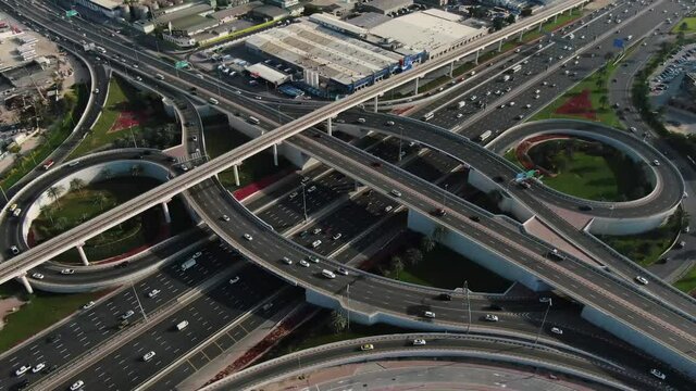 Traffic is passing across a very busy highway intersection in Dubai, UAE, 4k