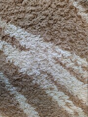 soft carpet of brown and white color closeup photo