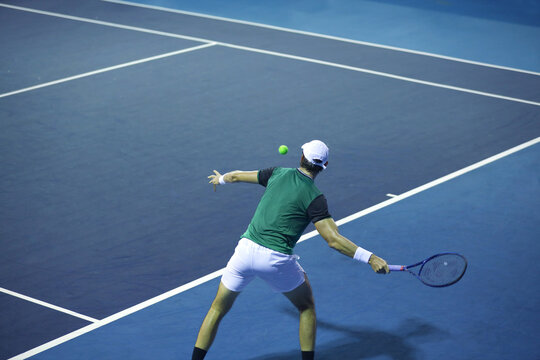 tennis player hitting the ball