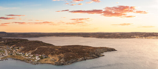 Aerial panoramic view of a town on the Rocky Atlantic Ocean Coast. Colorful Sunrise Sky Art Render. Taken in St. Anthony, Newfoundland, Canada.