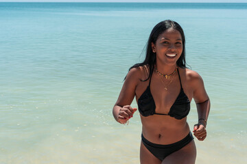 Beautiful African woman having fun in a beach
