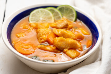 Fish soup with vegetables on white background. Mexican food