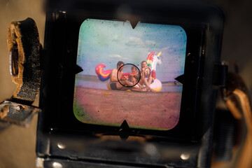 Happy family playing at the beach. Unicorn Colorful Inflatable Floating