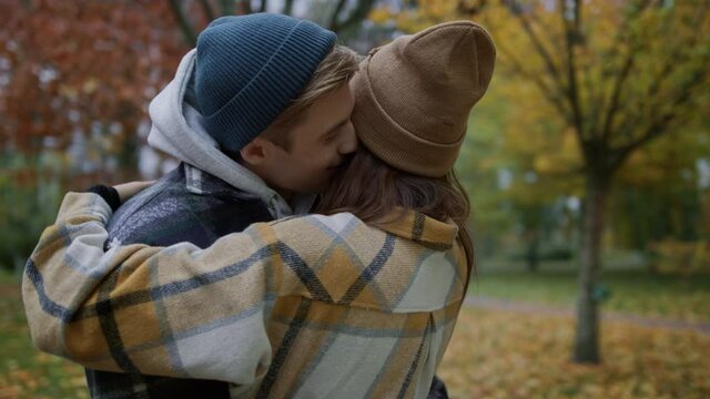Close up view of happy lovely couple standing in huggs on autumn nature. 
