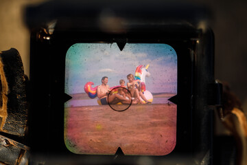 Happy family playing at the beach. Unicorn Colorful Inflatable Floating