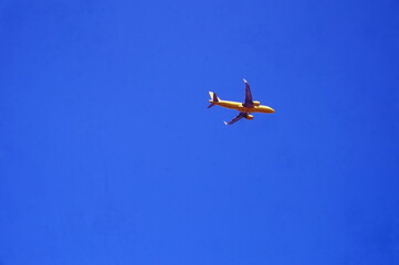 Yellow Passenger Plane in Afternoon Blue Sky