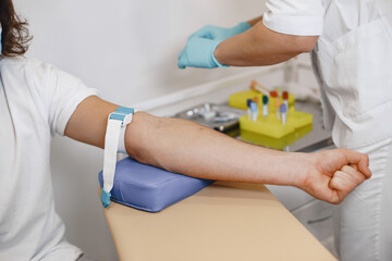 Nurse taking blood sample from patient at the doctors office