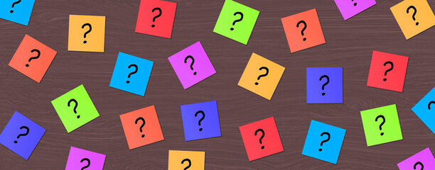 Many Colorful Sticky Note with question mark. Colored Block Notes Questions sign on wood background. Business Question, FAQ, and solution concept. 