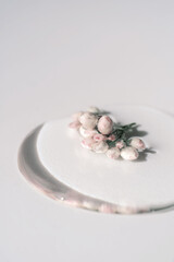 A drop of cosmetic gel with flower on a white background.