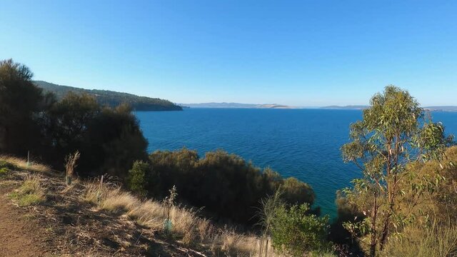 beautiful Tasmanian landscape with ocean view and thick vegetation shot from the Boronia walk in South Hobart