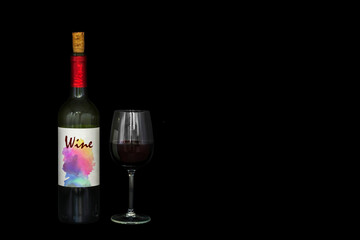 Bottle of red wine with colorful generic label and a crystal glass with wine. Black background..