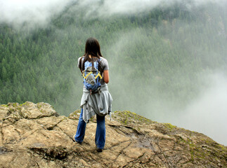 Young female hiker enjoying one of several over looks at the Little Si trail.