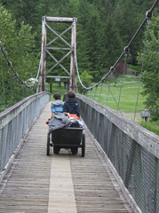 Young campers moving their camping gear across the bridge to Tolt-MacDonald camp site.