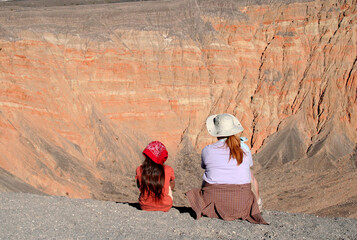 Tourist enjoying the scenic view of the Ubehebe Crater.  The crater is located in the northern half of Death Valley National Park, California, USA.