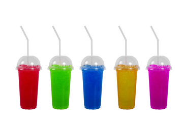 Various flavors of cold drinks in clear plastic glasses with covers and drinking straws isolated on white background.