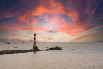 The beacon lighthouse under the gorgeous sunset by the sea