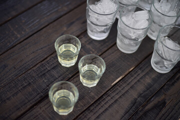 Glass of ice on wood table.