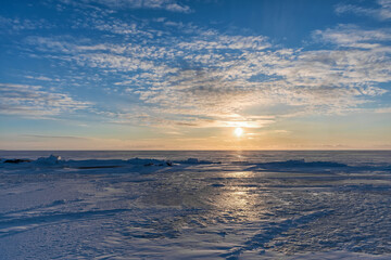 Fototapeta na wymiar Winter sunset on the lake, Pskov region, Russia