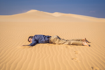 Exhausted man in the desert. Apathy, fatigue, exhaustion, mental disorders concept. Mental health