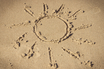 Fototapeta na wymiar Shape of sun written on sand at beach. Vacation time
