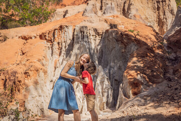 Mom and son tourists on the Fairy stream among the red dunes, Muine, Vietnam. Vietnam opens borders...