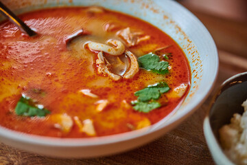 soup with seafood and mushrooms in a white plate